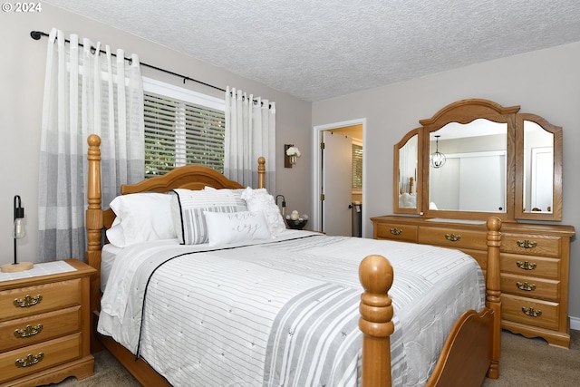 bedroom with light colored carpet and a textured ceiling