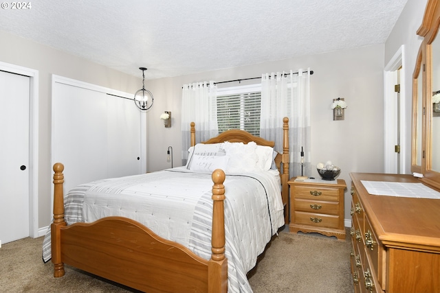 bedroom featuring light colored carpet and a textured ceiling