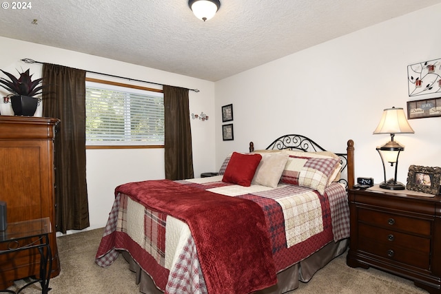 carpeted bedroom with a textured ceiling