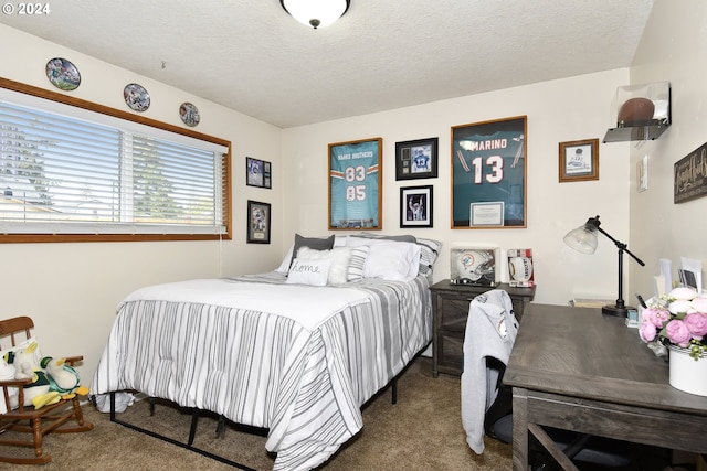 bedroom featuring carpet flooring and a textured ceiling