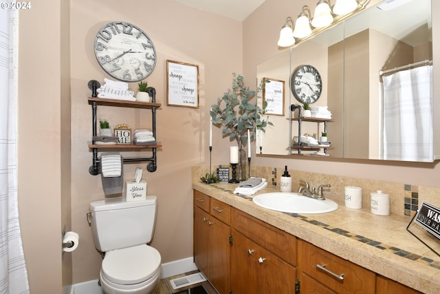 bathroom featuring vanity and toilet