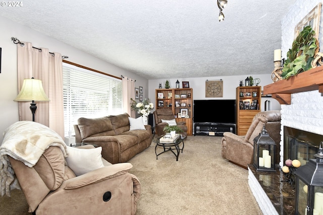 carpeted living room featuring a fireplace and a textured ceiling