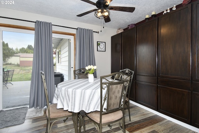 dining room with dark wood-type flooring, a textured ceiling, and ceiling fan