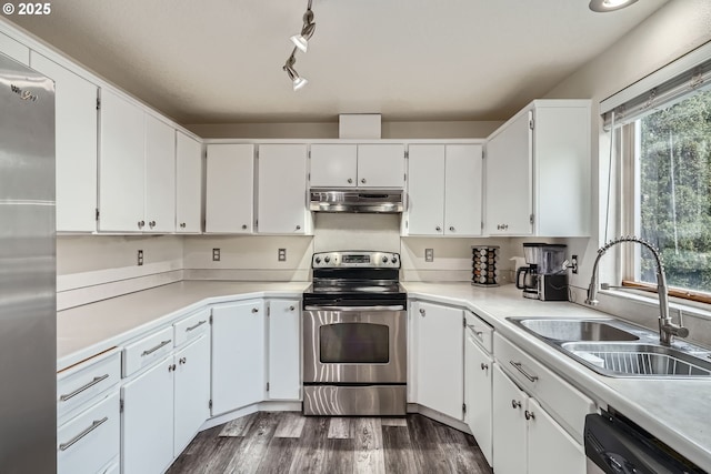 kitchen with under cabinet range hood, stainless steel appliances, dark wood-type flooring, a sink, and white cabinetry