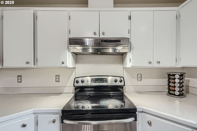 kitchen featuring electric stove, white cabinetry, and under cabinet range hood