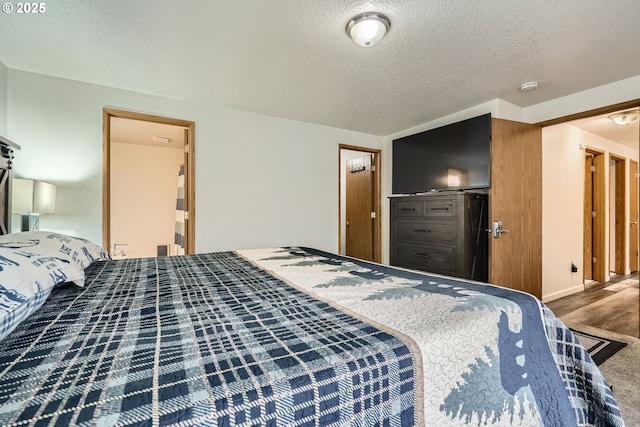 bedroom featuring a textured ceiling and wood finished floors