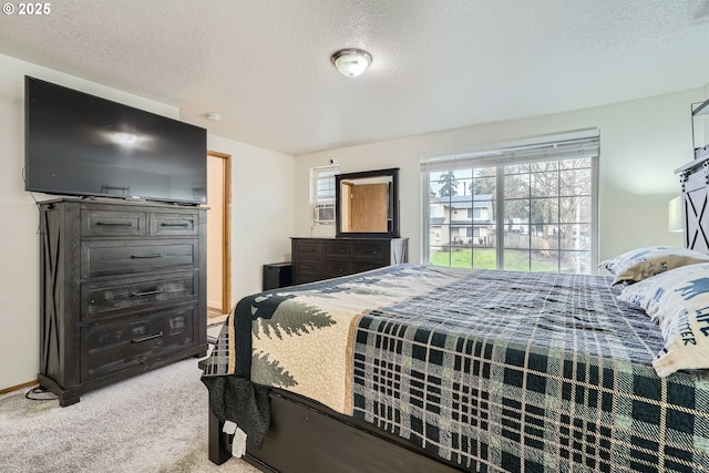 bedroom with a textured ceiling, carpet, cooling unit, and baseboards