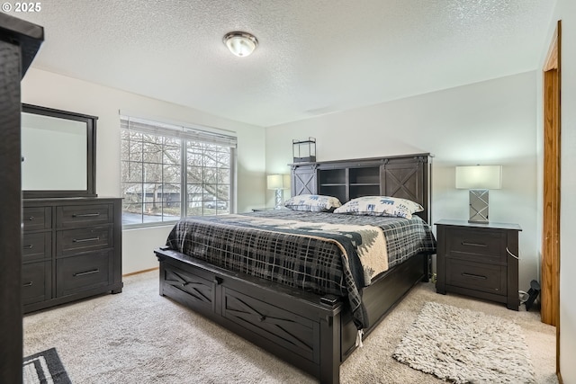 bedroom with light carpet and a textured ceiling