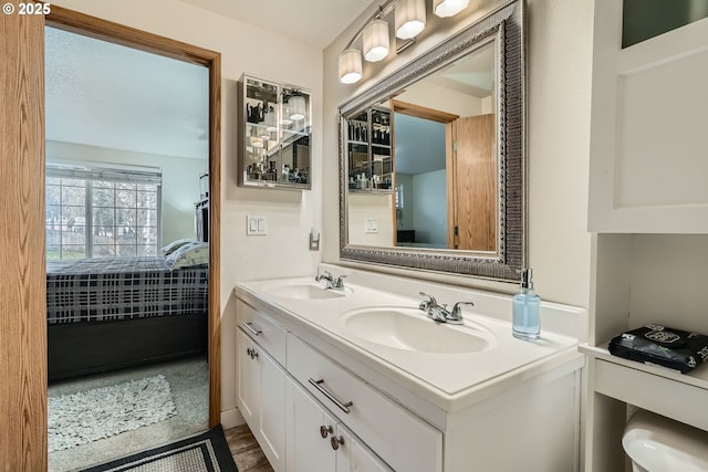 bathroom featuring double vanity, a sink, and ensuite bathroom