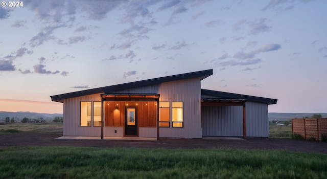 view of back house at dusk