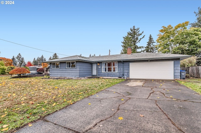 ranch-style house featuring a garage and a front yard