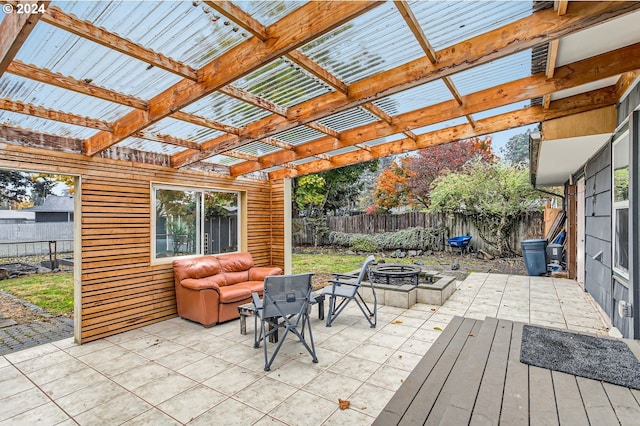 view of patio / terrace with a fire pit and a pergola