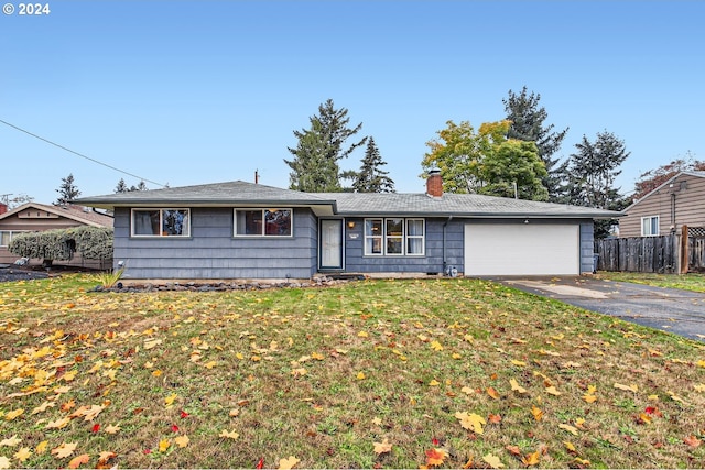 ranch-style home with a garage and a front yard