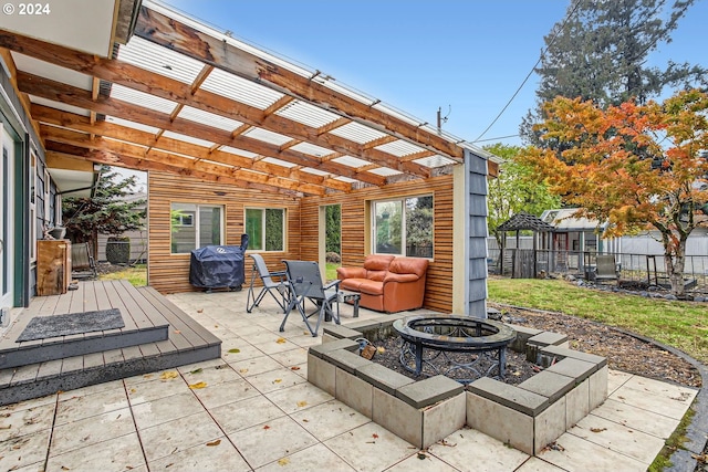 view of patio with an outdoor living space with a fire pit, a grill, and a pergola