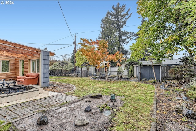 view of yard with a fire pit and a pergola