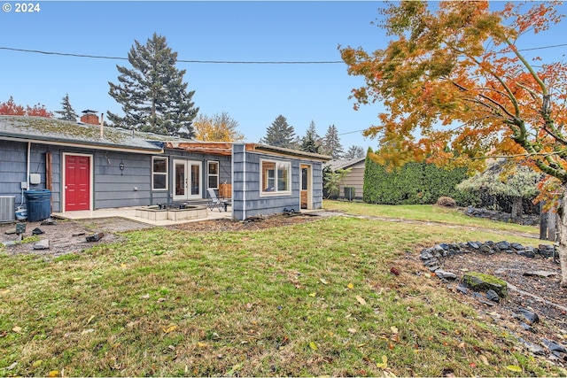 view of yard featuring a patio and french doors