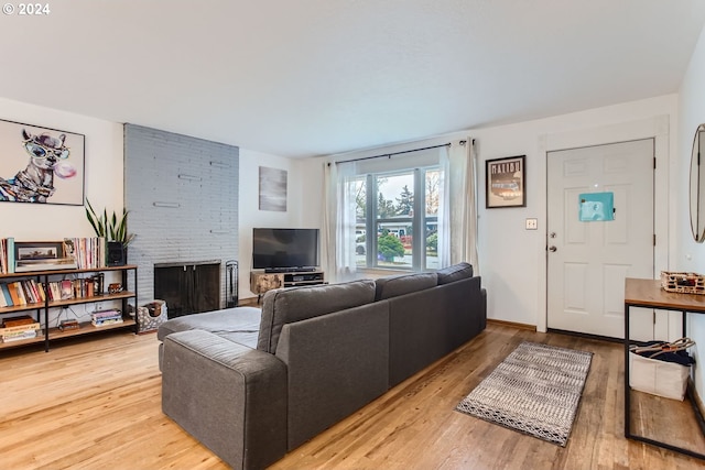 living room featuring a fireplace and light hardwood / wood-style flooring