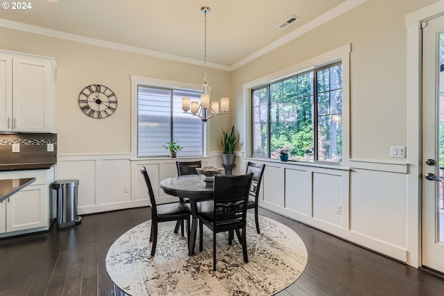 13632 SW 174th Loop, Sherwood, OR 97140 - dining space with dark wood-type flooring, crown molding, wainscoting, a decorative wall, and a chandelier