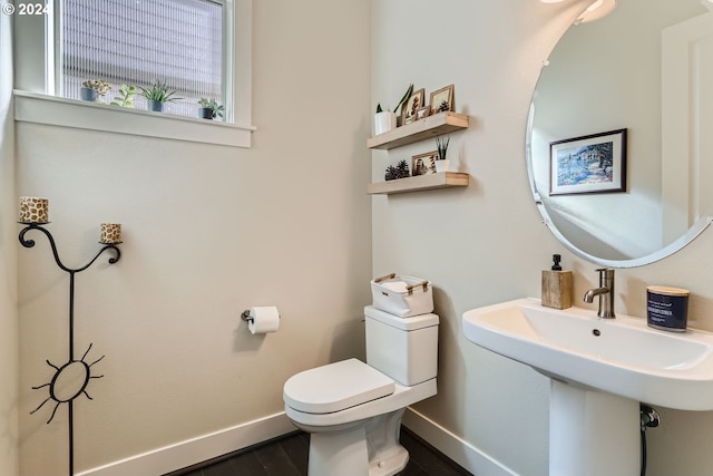 13632 SW 174th Loop, Sherwood, OR 97140 - half bath with baseboards, toilet, wood finished floors, and a sink
