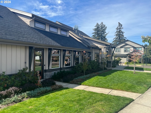 13632 SW 174th Loop, Sherwood, OR 97140 - view of front of house with roof with shingles, a front lawn, and board and batten siding