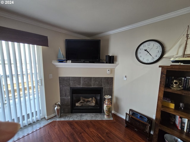 living room with wood-type flooring, a fireplace, and crown molding