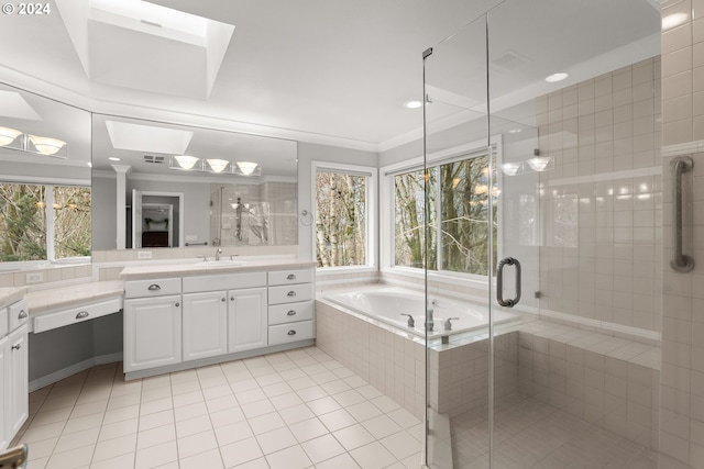 bathroom featuring a skylight, tile patterned floors, vanity, crown molding, and independent shower and bath