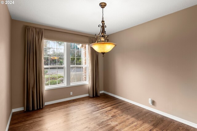 spare room with wood-type flooring