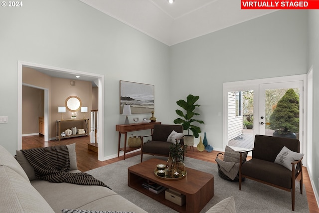 living room with a high ceiling and hardwood / wood-style flooring