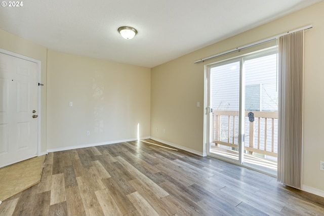 unfurnished room with light wood-type flooring