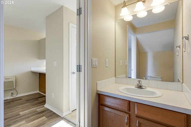 bathroom with hardwood / wood-style floors and vanity