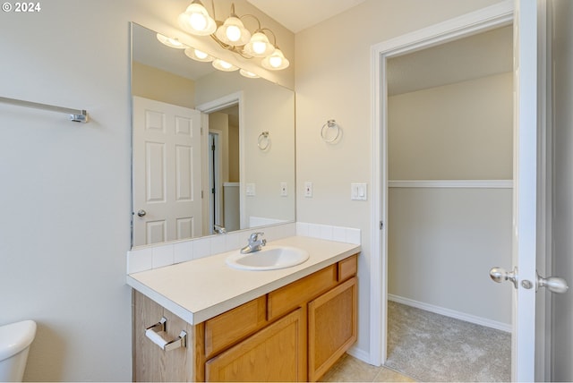 bathroom with toilet and vanity