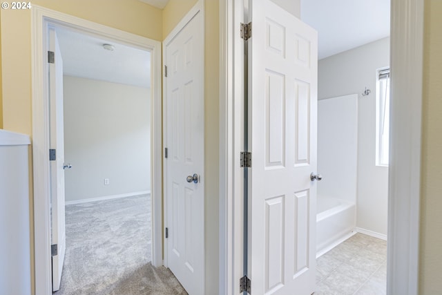 hallway with light colored carpet