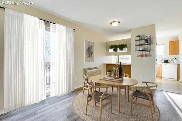 dining area featuring light hardwood / wood-style flooring and a wall mounted AC