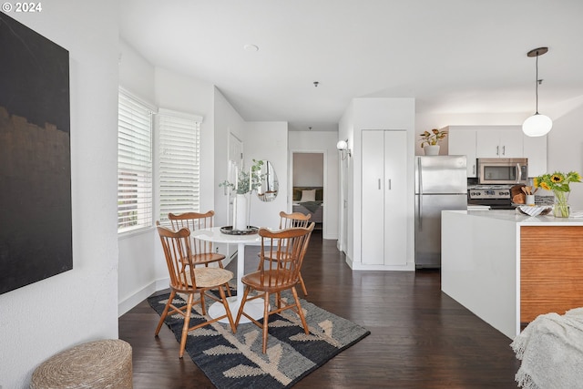 dining space with dark hardwood / wood-style floors