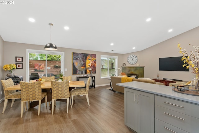 dining space featuring light hardwood / wood-style flooring and vaulted ceiling