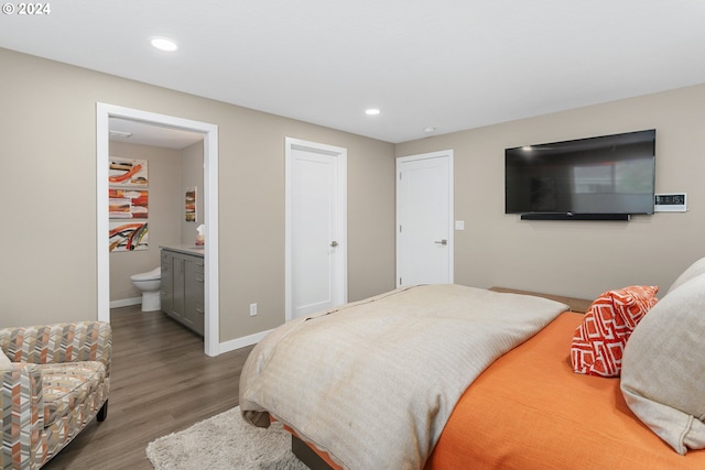 bedroom featuring hardwood / wood-style flooring and ensuite bath