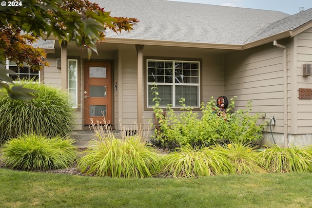 property entrance with a lawn