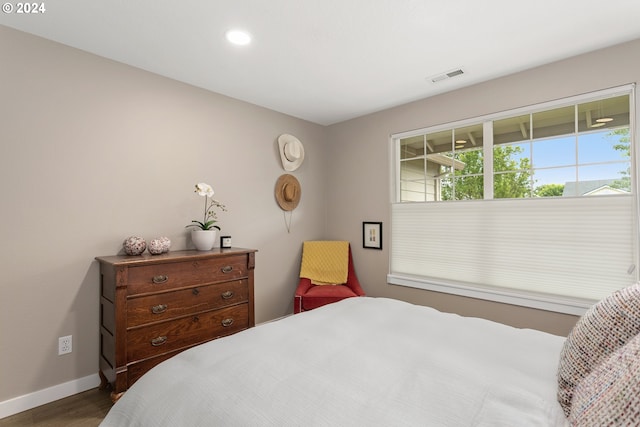 bedroom with dark hardwood / wood-style flooring