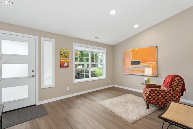 entrance foyer with light hardwood / wood-style flooring and lofted ceiling