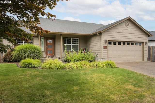 ranch-style house featuring a garage and a front yard