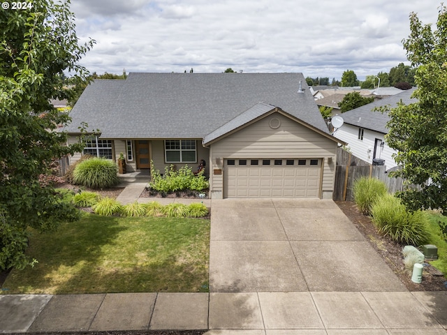 view of front of property with a garage and a front lawn