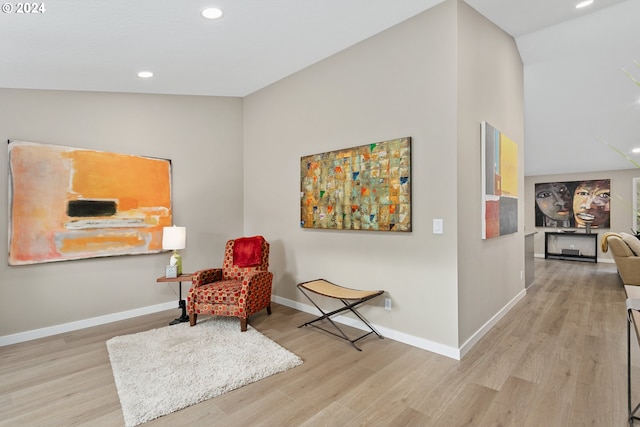 sitting room featuring light hardwood / wood-style floors and vaulted ceiling