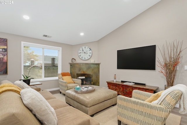 living room with lofted ceiling and light wood-type flooring