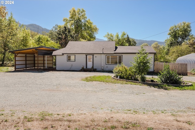 single story home featuring a mountain view and a carport