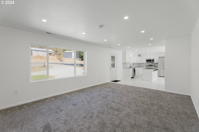 2840 Canyonville Riddle Rd, Riddle, OR 97469 - unfurnished living room with recessed lighting, visible vents, light colored carpet, and baseboards