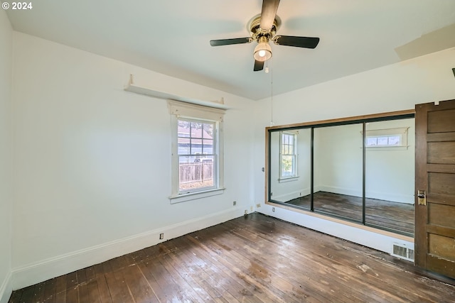 234 Loves Ave, Woodland, WA 98674 - unfurnished bedroom with dark wood finished floors, visible vents, a ceiling fan, a closet, and baseboards