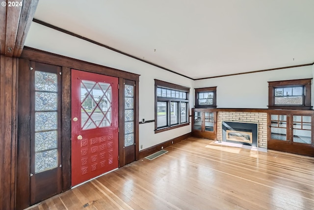 234 Loves Ave, Woodland, WA 98674 - entrance foyer with a brick fireplace, hardwood / wood-style flooring, baseboards, and a healthy amount of sunlight