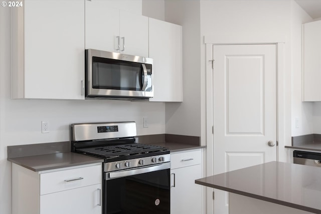 kitchen featuring stainless steel appliances and white cabinets