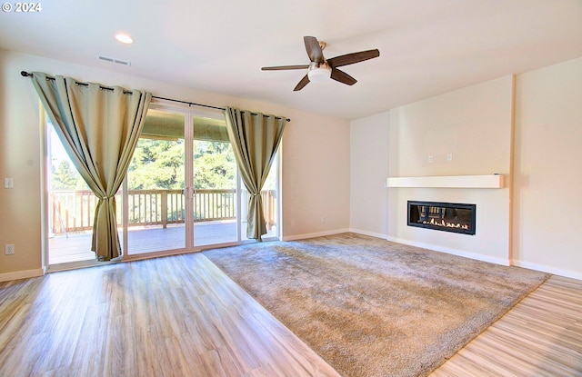 unfurnished living room featuring ceiling fan and light hardwood / wood-style flooring