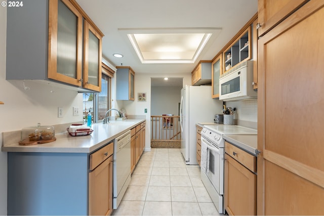 kitchen featuring light tile patterned flooring, white appliances, and sink